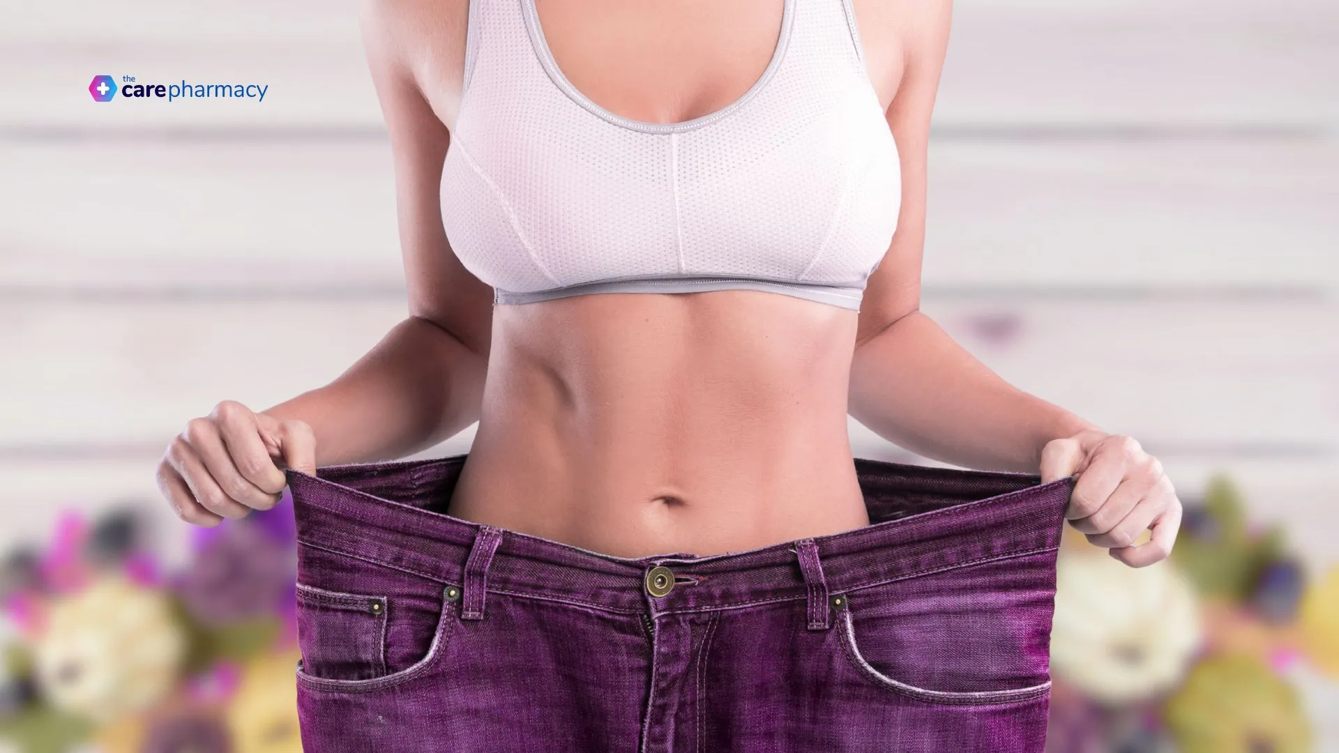 Woman showing weight loss by stretching her jeans